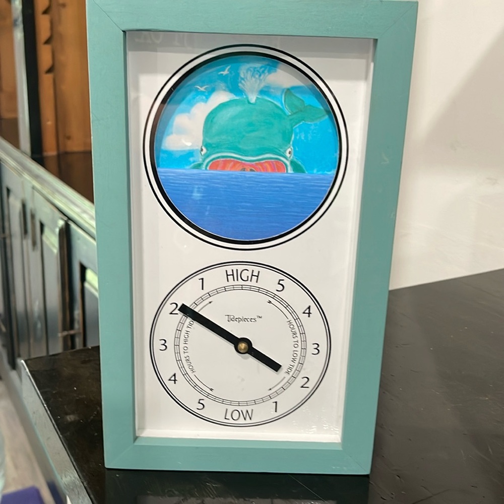 TidePieces Whale tide clock in a greenish wood housing.